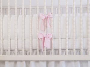 White linen crib bumper with pink  ties